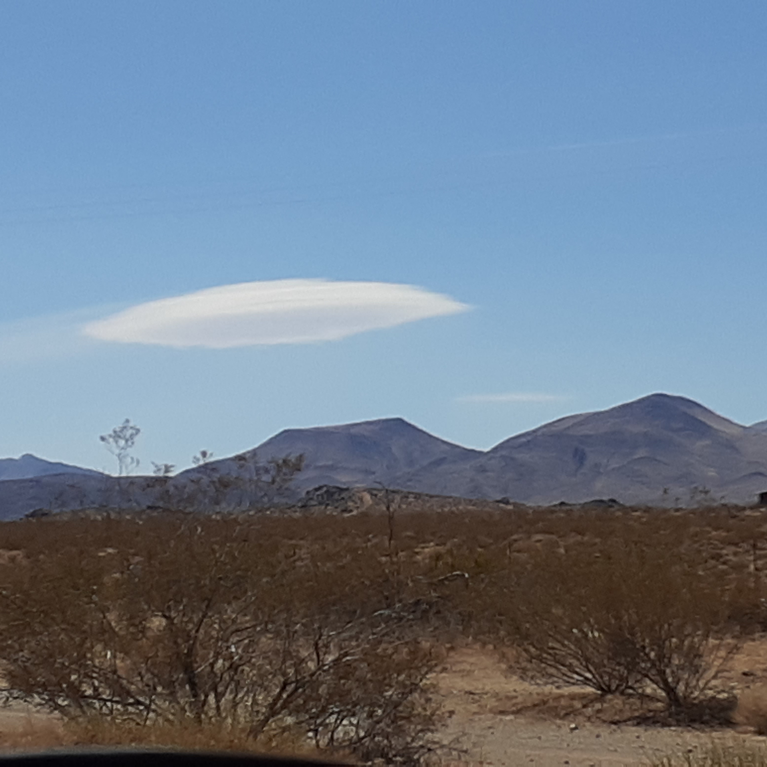 Lenticular cloud over desert landscape